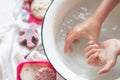 ChildÃ¢â¬â¢s hands under white bowl with water upon water stream Royalty Free Stock Photo